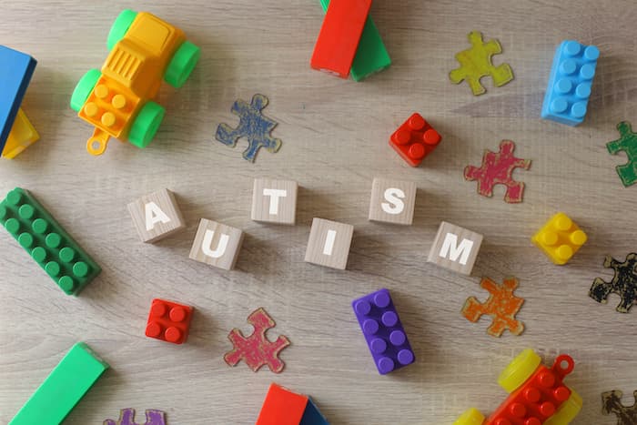 Various colourful pieces of puzzle with the word autism